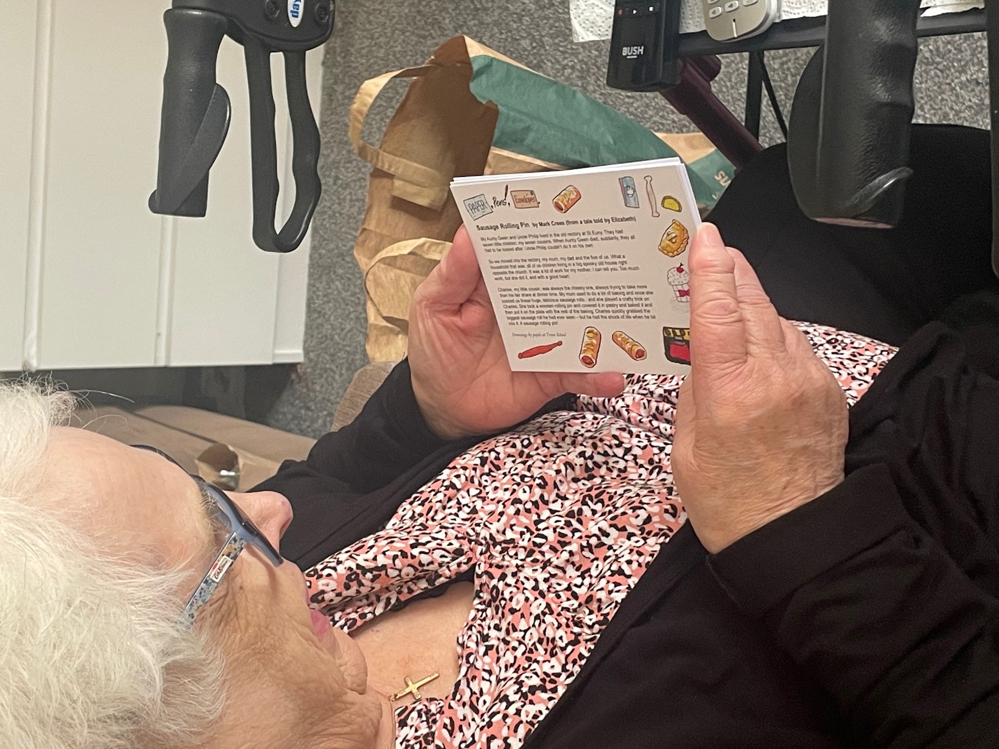 Elderly woman reads a postcard